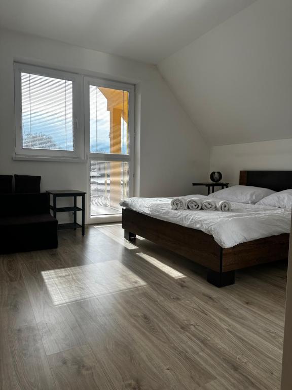 a bedroom with a bed and a large window at Bikehouse in Veľká Lomnica