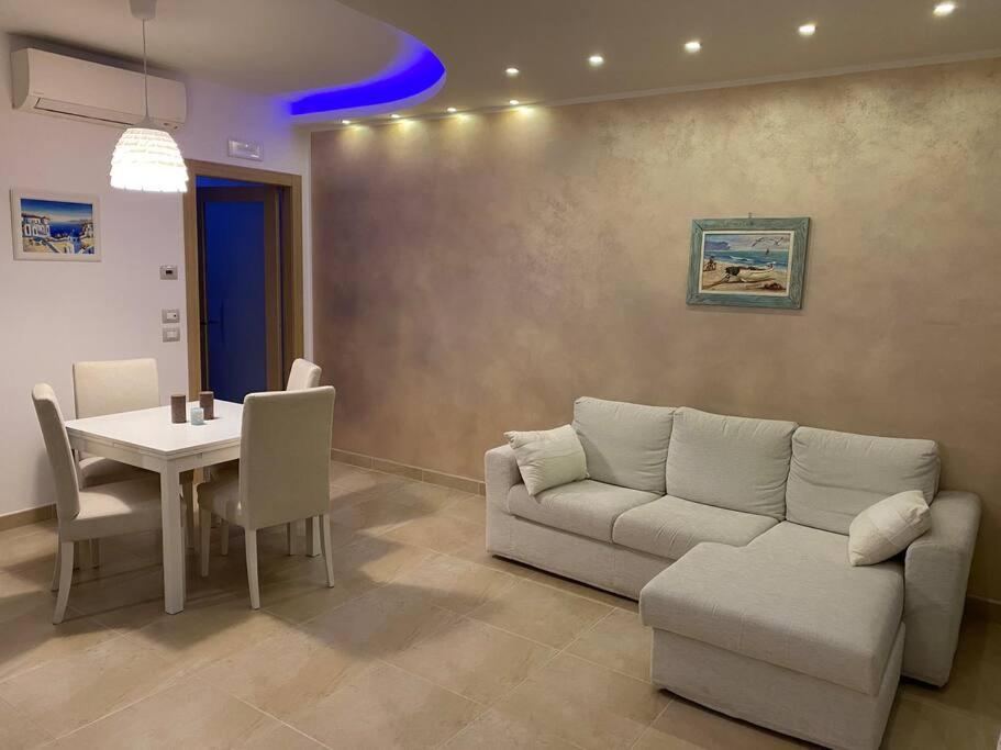 uma sala de estar com um sofá e uma mesa em Appartamento al mare - Porto Recanati em Porto Recanati