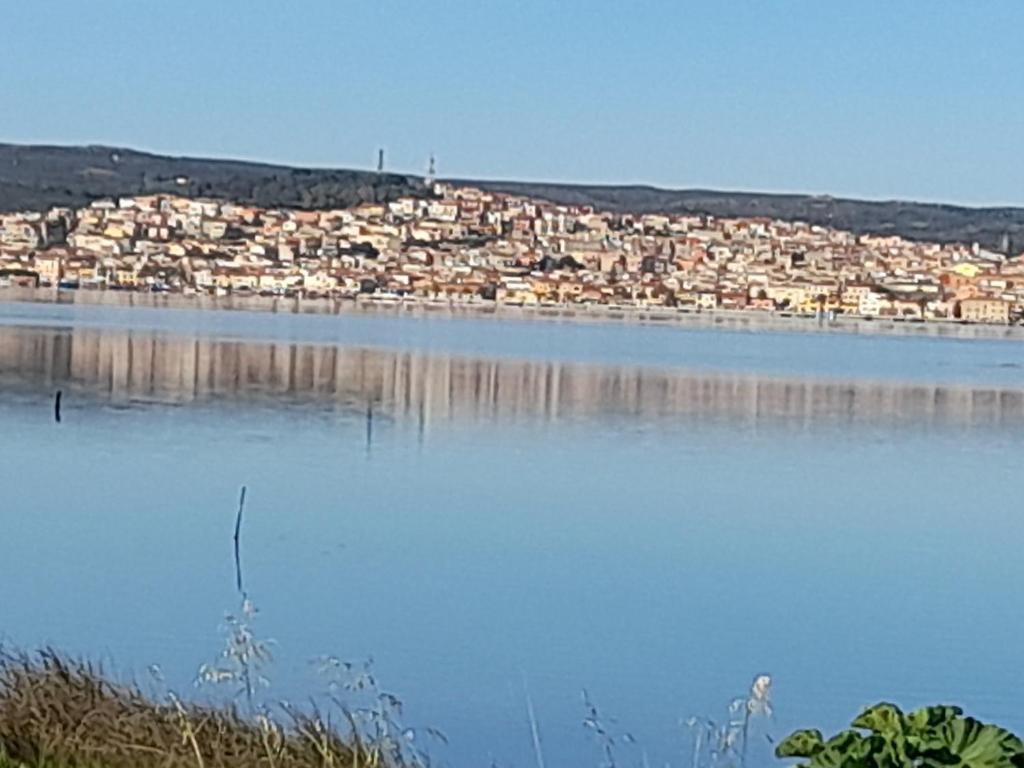 a large body of water with a city in the background at Appartamento centro in SantʼAntìoco