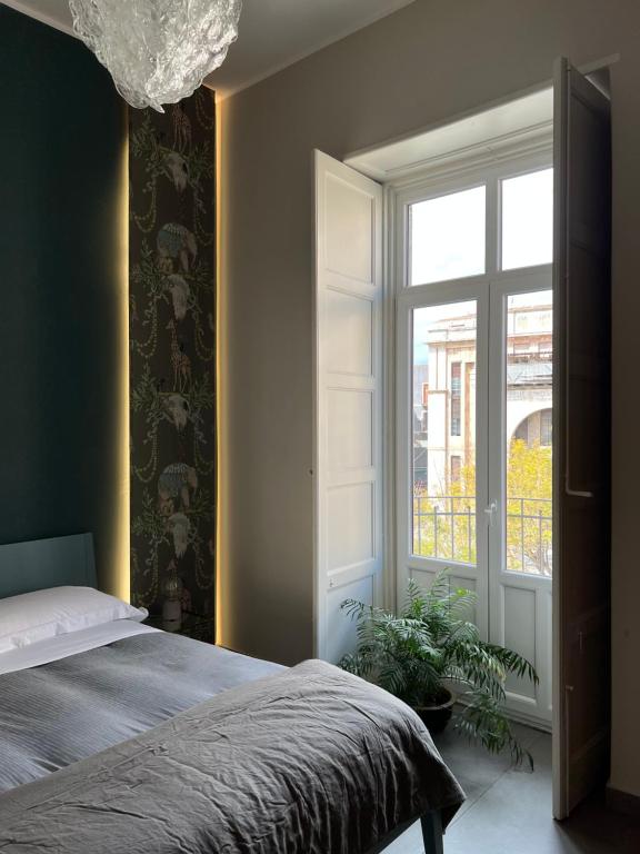 A bed or beds in a room at Catania Rooms