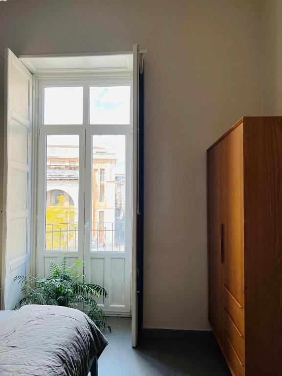 A bed or beds in a room at Catania Rooms