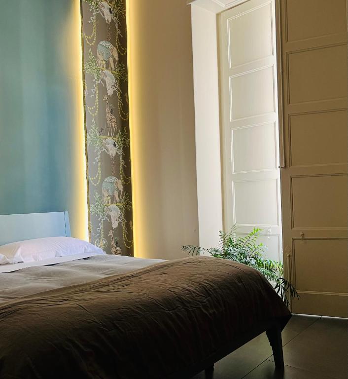 A bed or beds in a room at Catania Rooms