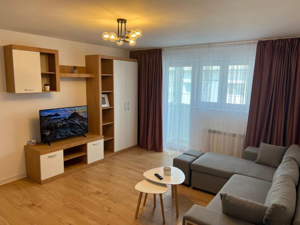 a living room with a couch and a table at Sunny Apartment in Suceava in Suceava