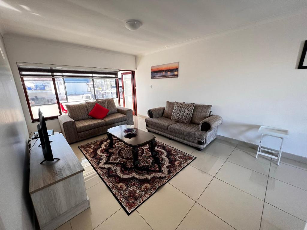 a living room with two couches and a coffee table at Safi Luxury Apartment 7 in East London