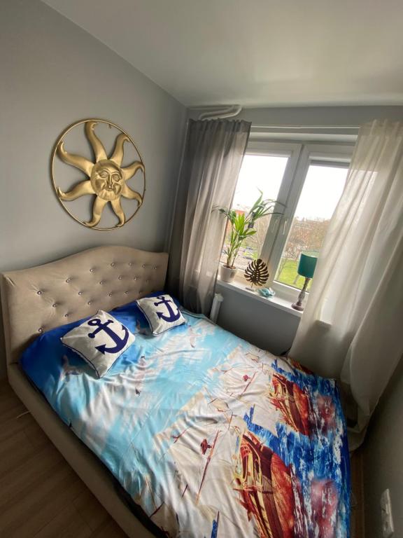 a bedroom with a bed with two pillows on it at Gdańska Marina- Śródmieście in Gdańsk