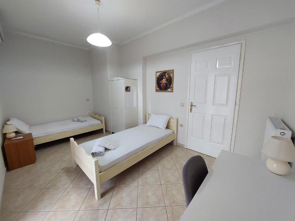 Postel nebo postele na pokoji v ubytování Kallistimon House