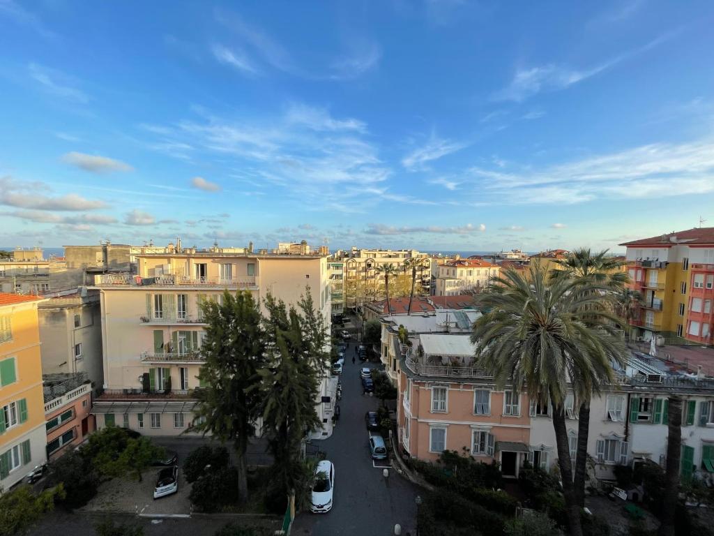 a view of a city with palm trees and buildings at Casa vacanze Nido al Mare in Sanremo