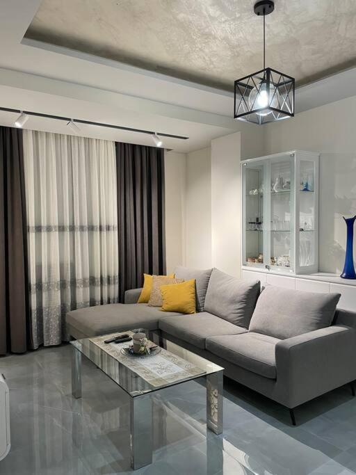 a living room with a couch and a table at Apartment Aulona Park in Vlorë