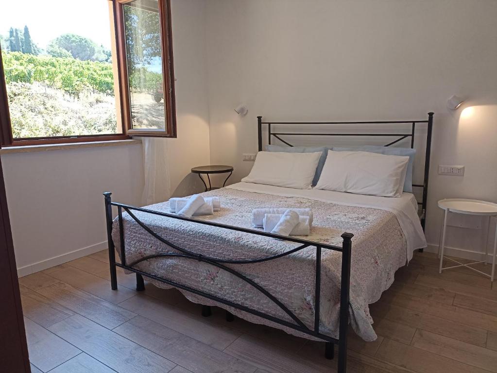 a bedroom with a bed with a glass table on it at La Residenza di Campagna in Manciano