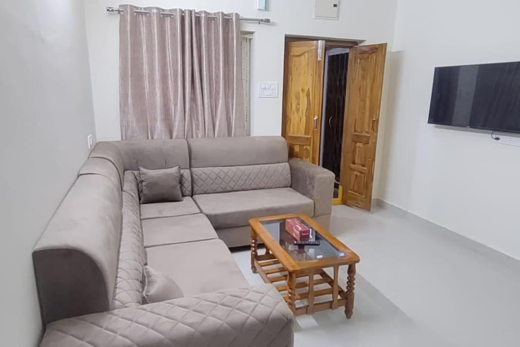 a living room with a couch and a coffee table at 2 Bhk Fully Furnished Hafeezpet #101 in Hyderabad