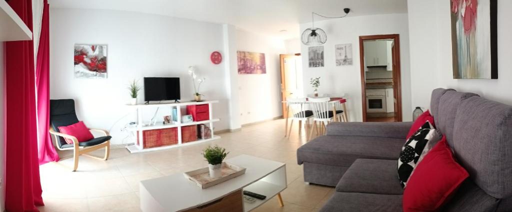 a living room with a couch and a table at Centro Histórico de Málaga in Málaga