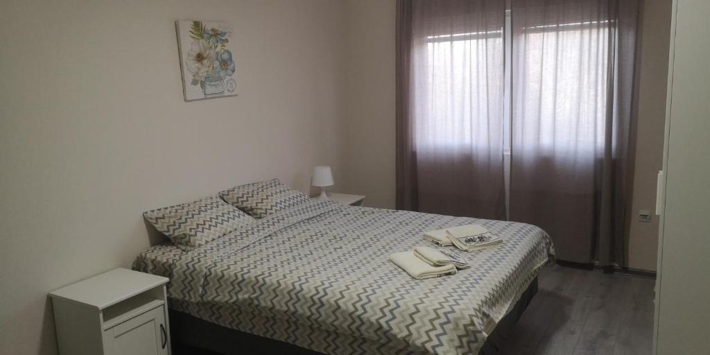 a bedroom with a bed with two books on it at Sokobanja apartman Aviva in Soko Banja