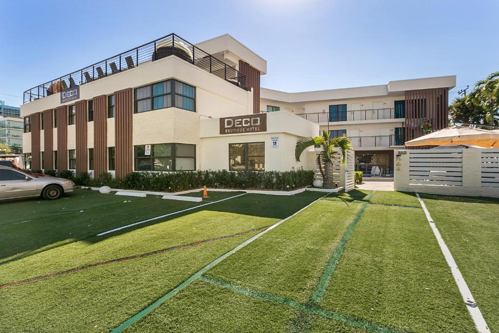 a large building with a lawn in front of it at Deco Boutique Hotel in Fort Lauderdale