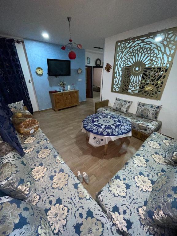 a living room with two couches and a tv at coin du repos in Oujda