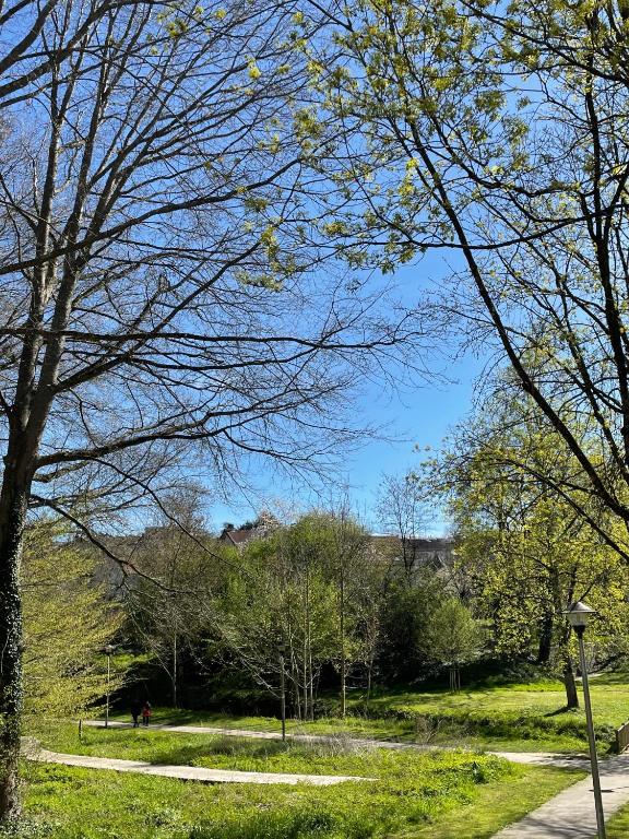 a park with trees and a path in the grass at La Maison de l'Auzette in Limoges