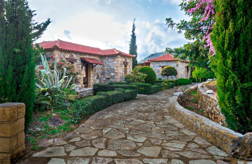 a stone path in front of a house at Porto Kalamitsi Stone-built Bungalows in Kardamili