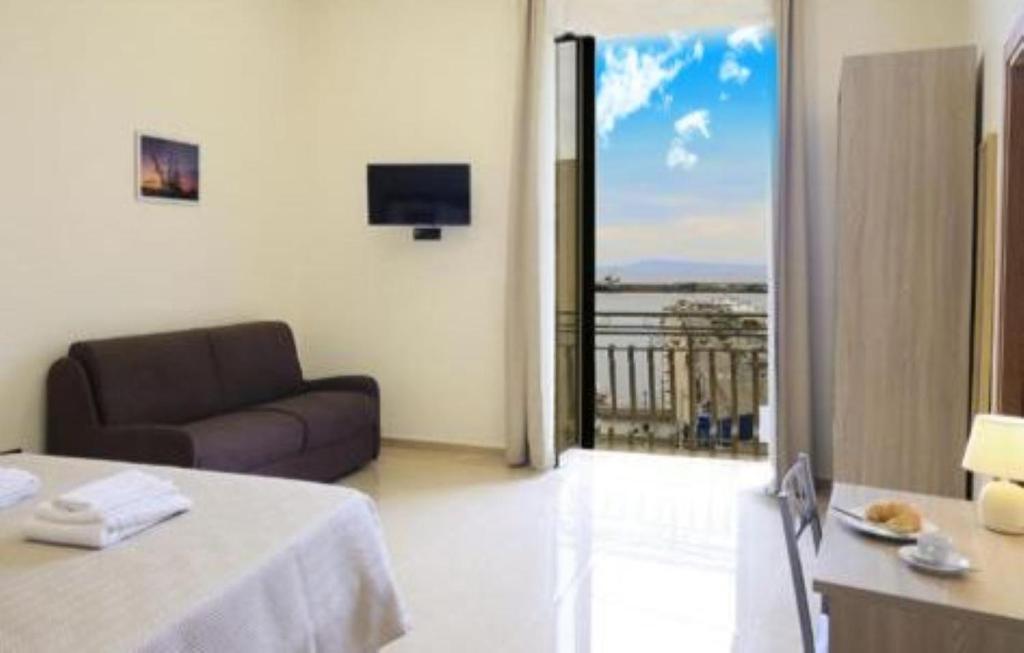 a living room with a couch and a balcony at AM suite Stabiae in Castellammare di Stabia