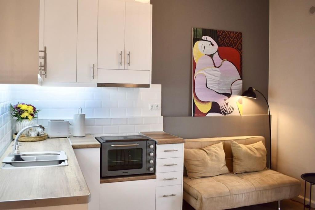 a small kitchen with a sink and a microwave at KAPA Central Apartment in Kalamata