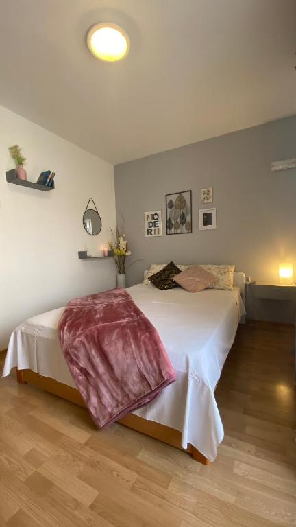 a bedroom with a large bed in a room at Guest House Tonica in Krk