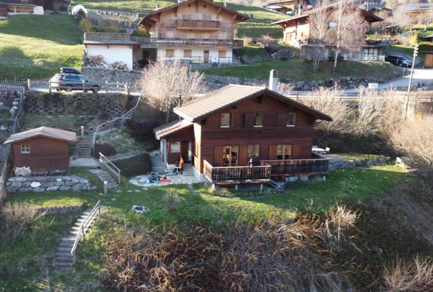 a small wooden house on a hill with houses at Chalet Villars-Gryon 8pax Cosy in Gryon