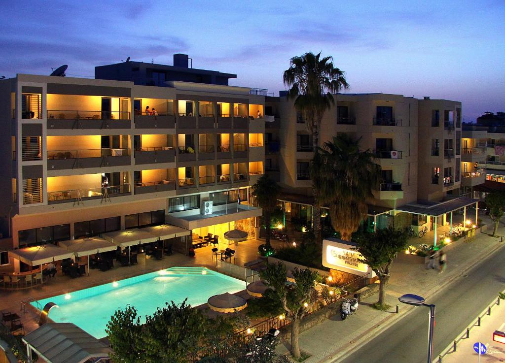 a large building with a swimming pool in front of it at Saint Constantine Hotel in Kos Town