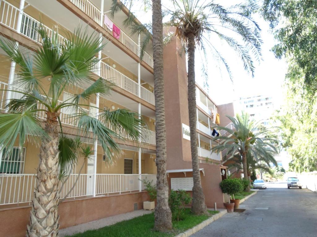 a building with palm trees in front of it at Falcon (Beach & Golf) in Playa de San Juan