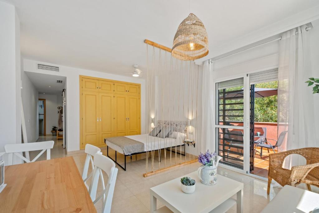 a living room with a table and a dining room at Niña Sureña Home Añoreta Golf in Torre de Benagalbón