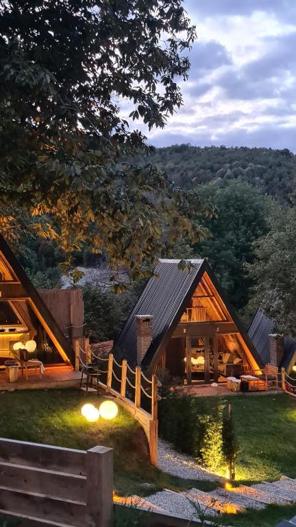 a cabin with a wooden roof and a fence at Loca Sapanca Bungalov in Sapanca