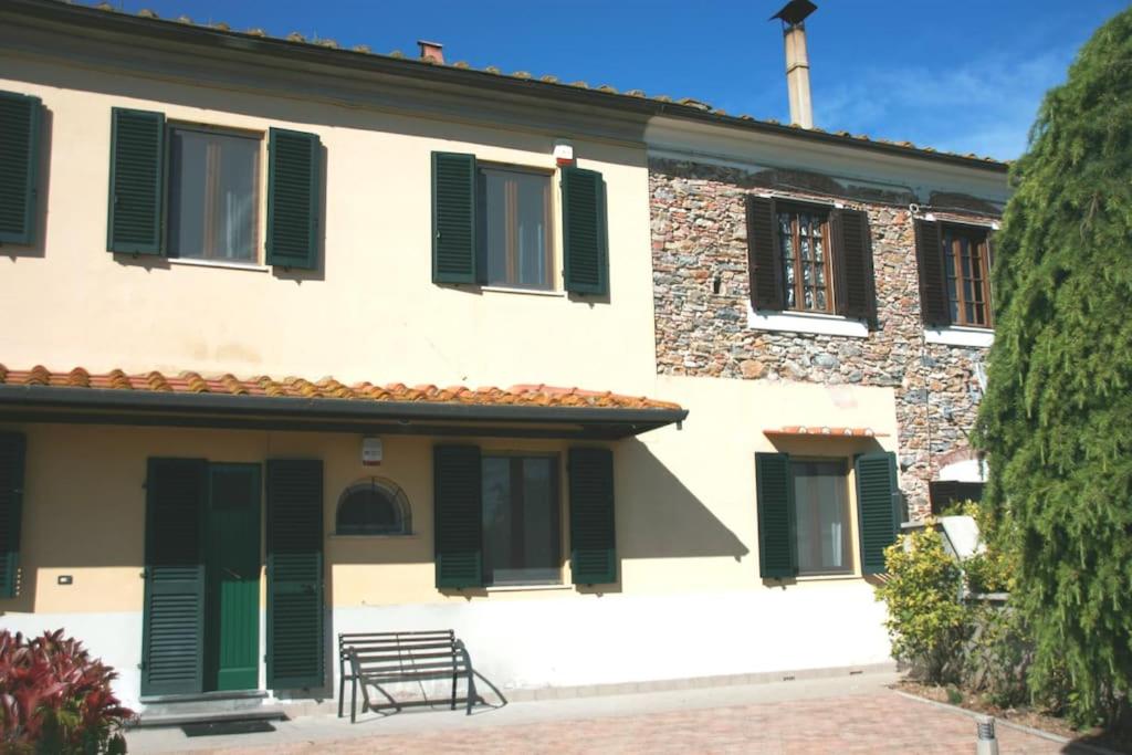 a building with green shutters on it at Brekkafest in San Giuliano Terme
