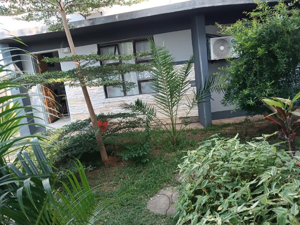 a house with a garden in front of it at Shalakwe Hills-Inn B&B Kasane in Kasane