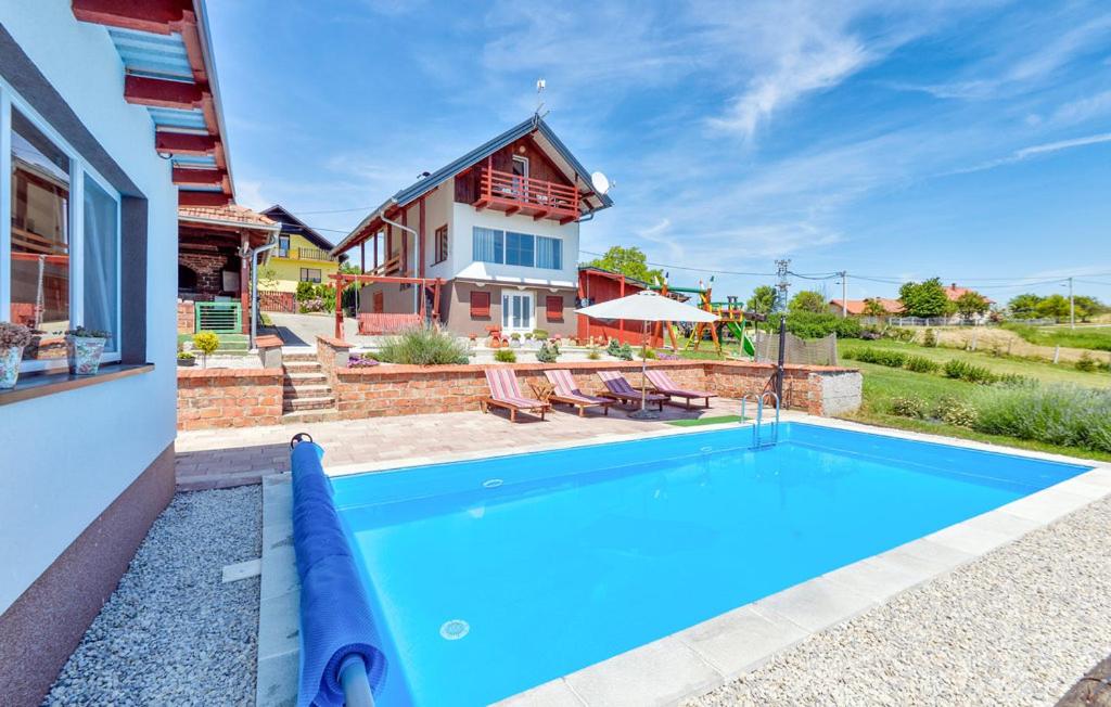 a house with a swimming pool in front of a house at Kuća za odmor Hren in Mursko Središće