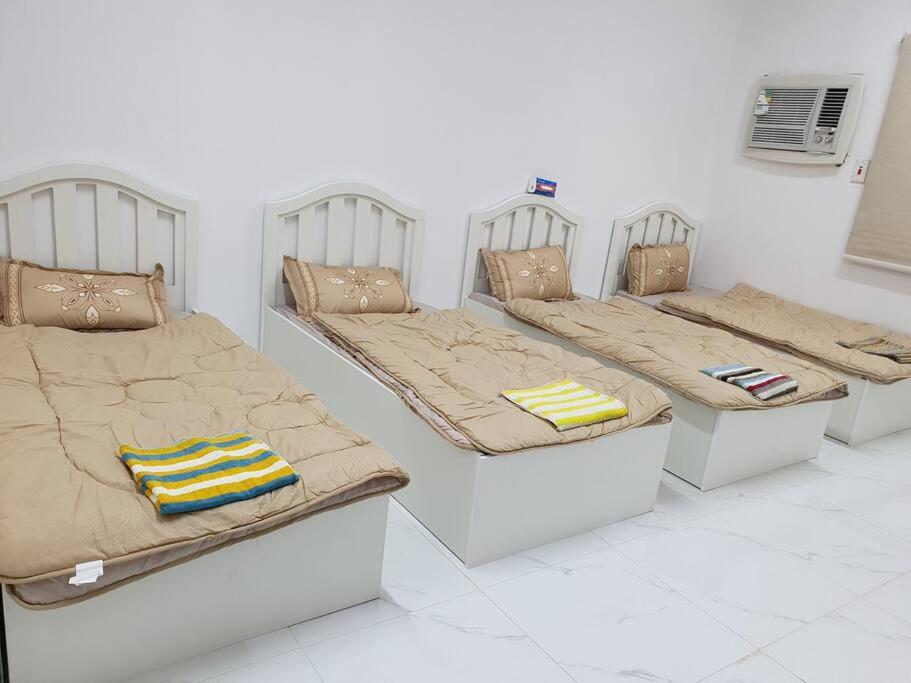 two beds with pillows on them in a room at شقة مفروشة رقم 1 تبعد عن الحرم النبوي الشريف 3 كم in Al Madinah