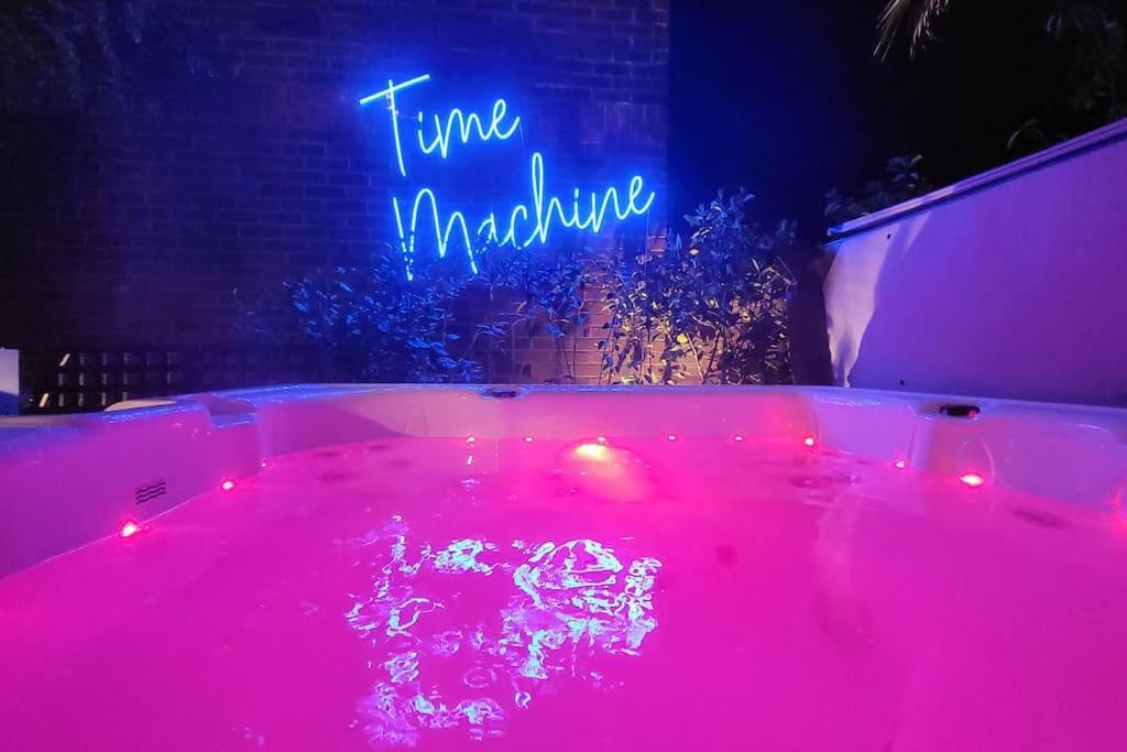 a pink tub with a sign that says trueomnia at Arundel Castle River House, The Palms in Arundel