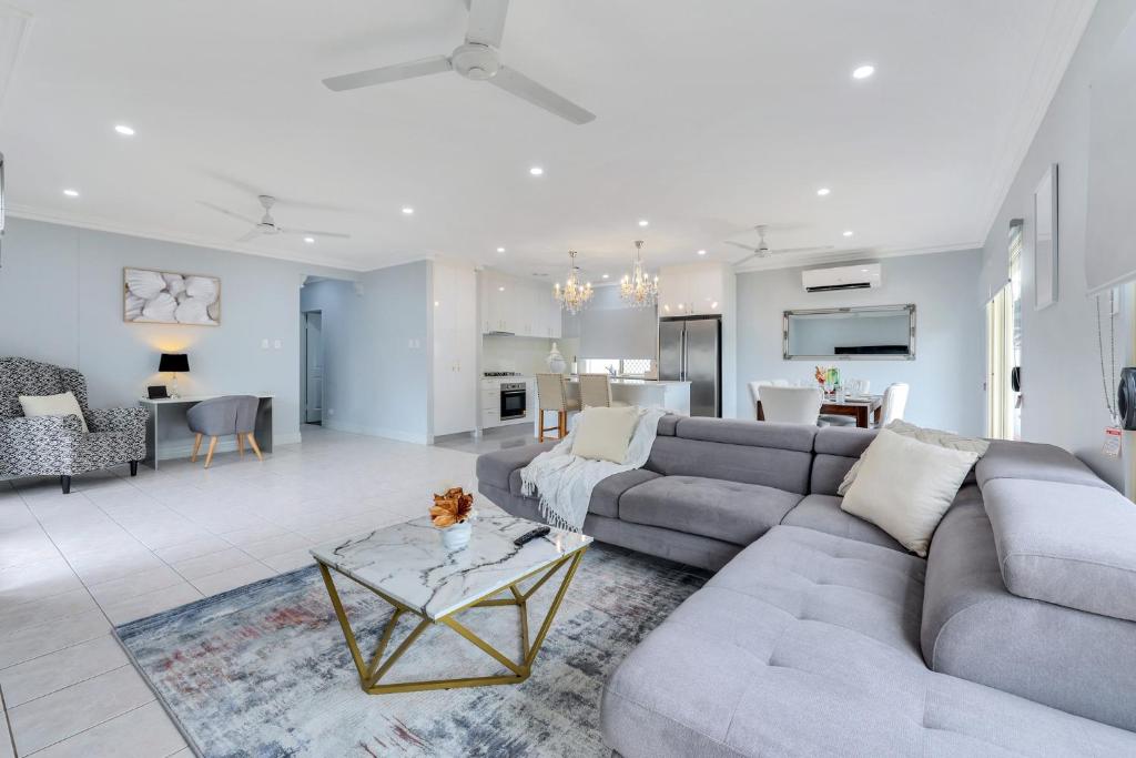 a living room with a couch and a table at The OC Home: Centrally Located, Home Away Home in Nightcliff
