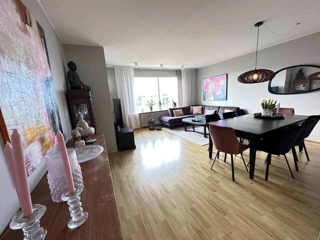 a living room with a table and a dining room at Cosy apartment centrally located in Reykjavik in Reykjavík