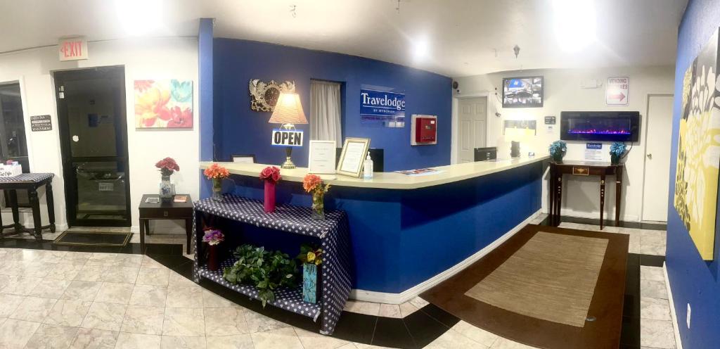 a lobby of a pharmacy with a blue wall at Travelodge by Wyndham Junction City in Junction City