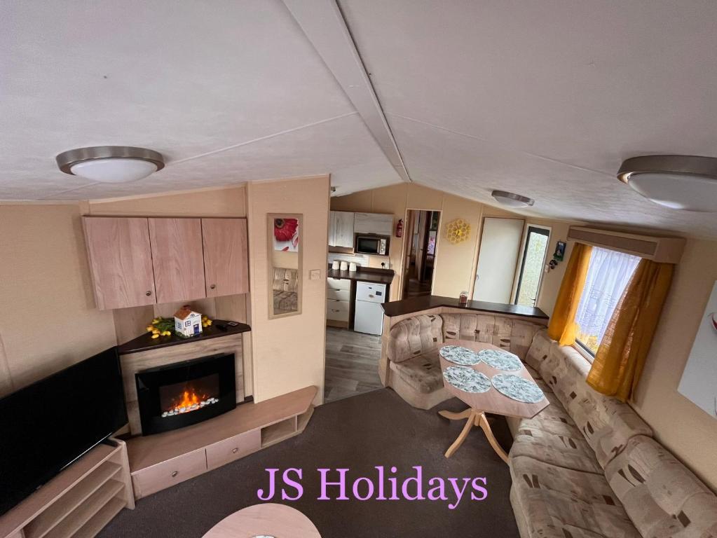 an aerial view of a kitchen and living room with a fireplace at JS Holidays The Westmorland Lagganhouse in Ballantrae