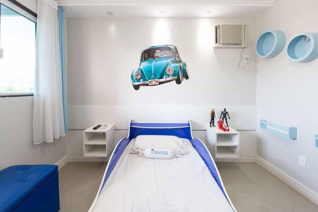 Un pat sau paturi într-o cameră la Casa de praia no Recreio