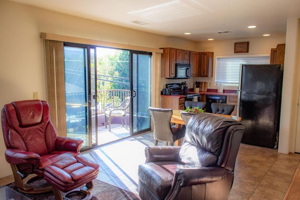 a living room with a couch and chairs and a kitchen at Shaman's Den - Aptly decorated space w/a view in Sedona