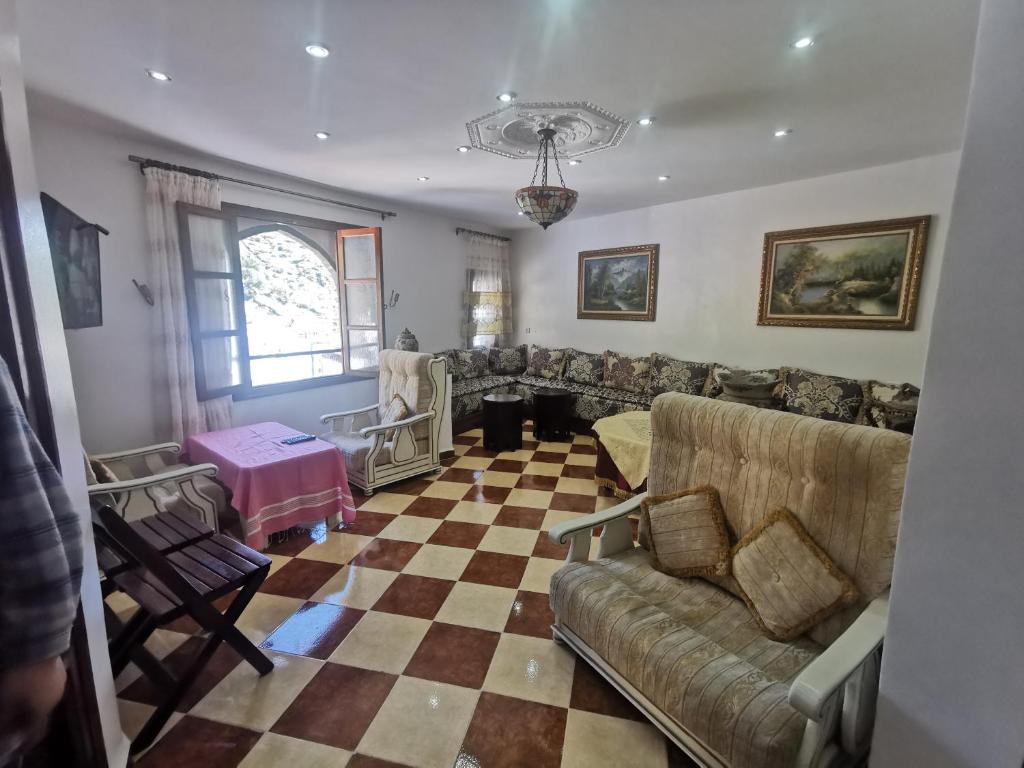 a living room with a couch and a checkered floor at Cascadas al Onsar Chefchauen in Chefchaouen