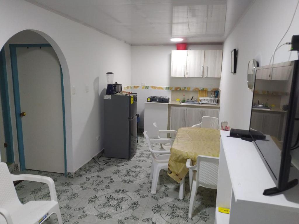 a kitchen with a table and chairs in a room at Apartamentos AJ place 2 in San Andrés