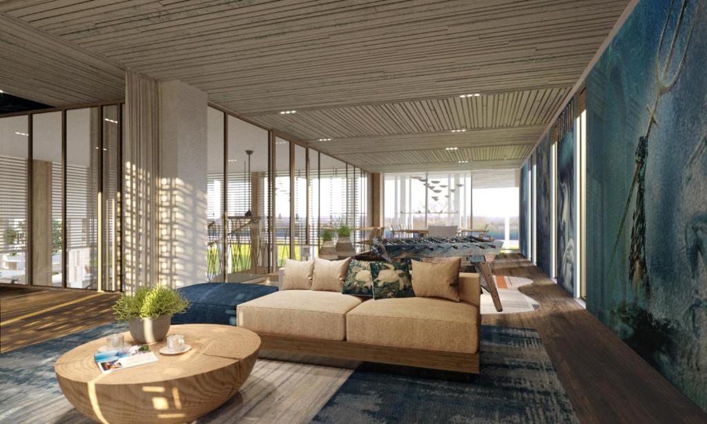 a living room with a couch and a table at TTC Van Phong Bay Resort - Himalaya Sauna & Steam Retreat Included in Ninh Hòa