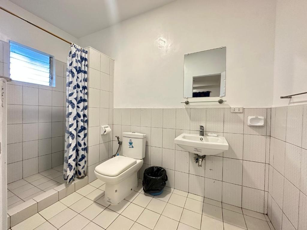 a bathroom with a toilet and a sink at CafeMare Rooms in Bantayan Island