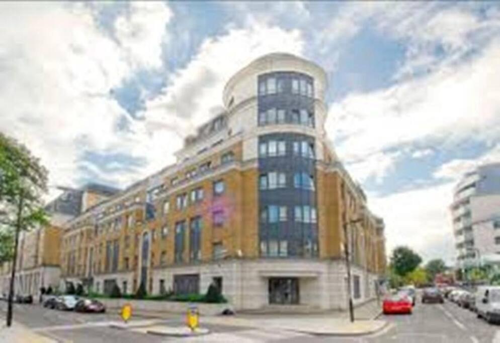a large building on the corner of a street at A 2 standard bedrooms flat in London