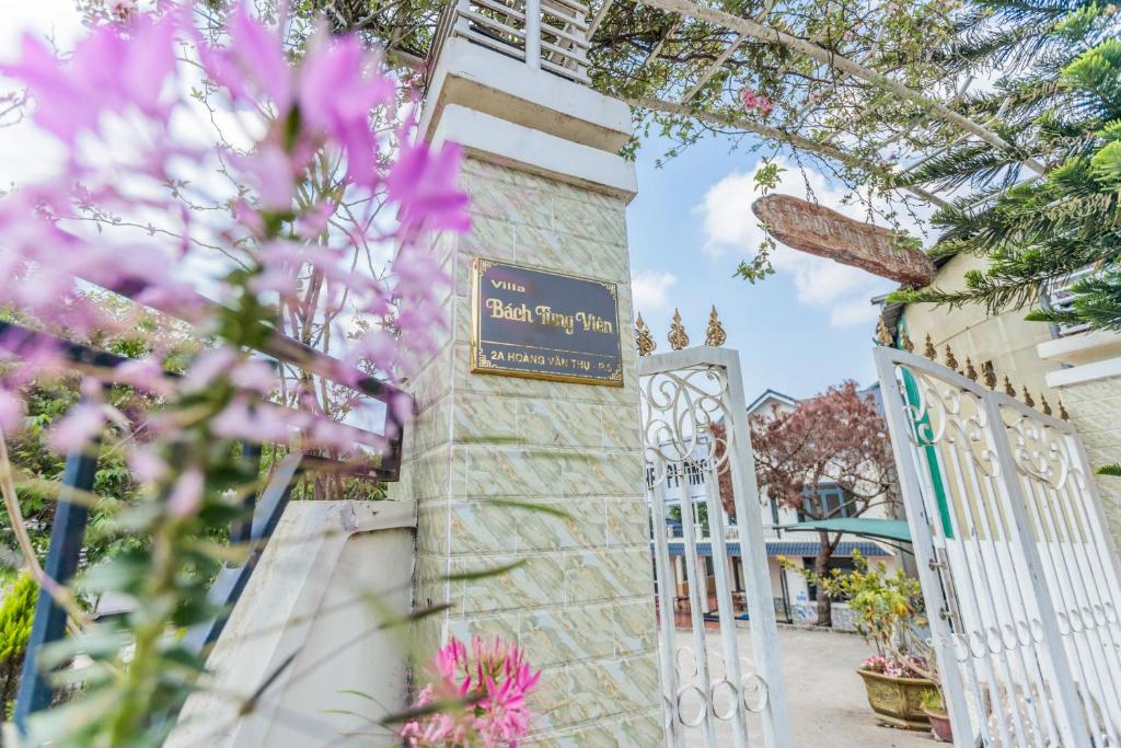 a gate in front of a building with pink flowers at Bách Tùng Viên Villa Đà Lạt in Ấp Kim Thạch