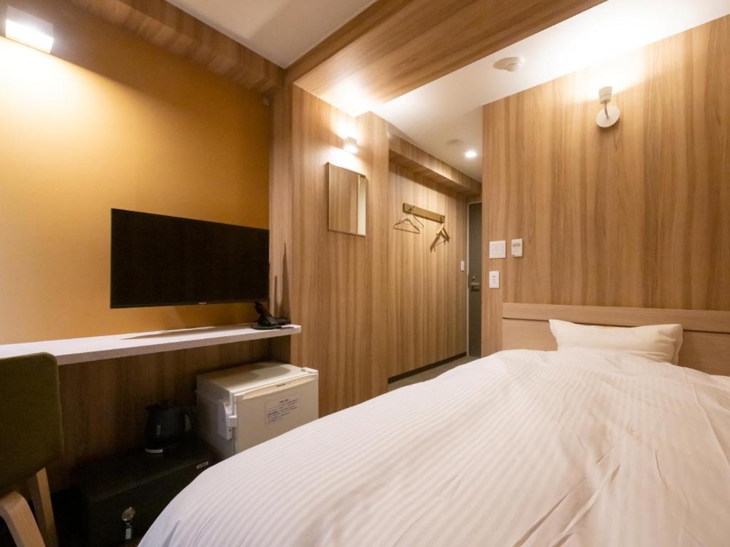 Postel nebo postele na pokoji v ubytování Hotel Oyanagi