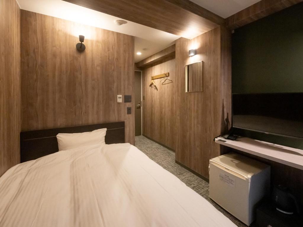 Postel nebo postele na pokoji v ubytování Hotel Oyanagi