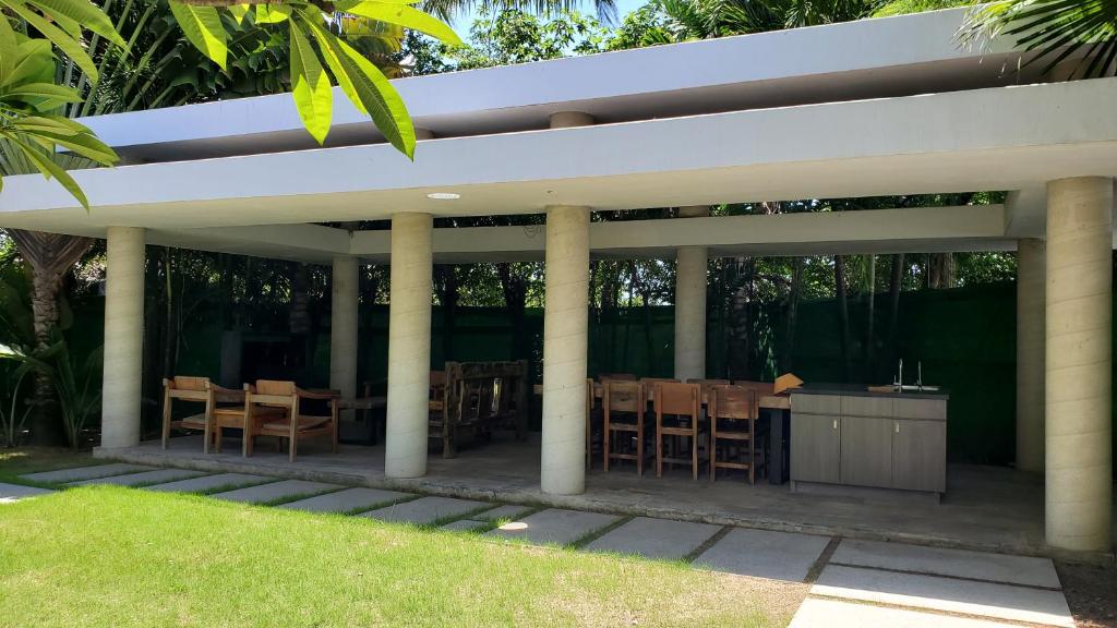 a pavilion with tables and chairs in a garden at Fu Wan Cafe Villa in Donggang