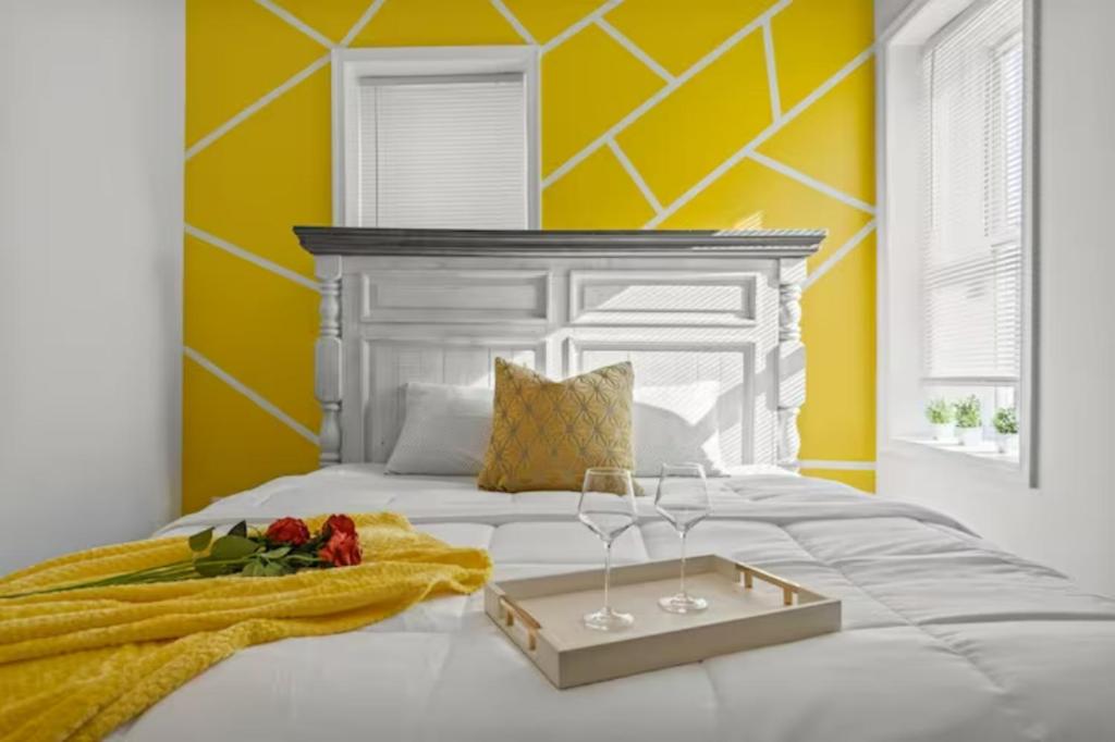 a white bed with a tray on top of it at Cozy&Chic Apartments Near Downtown in Philadelphia