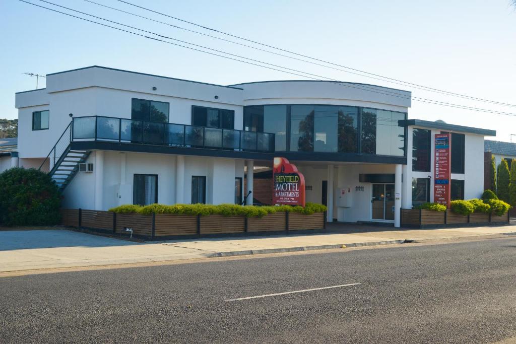 a white building on the side of a street at Heyfield Motel and Apartments in Lakes Entrance